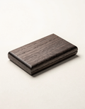 Order Card Case — Walnut — Black walnut card case. 108 × 68 × 13 mm.