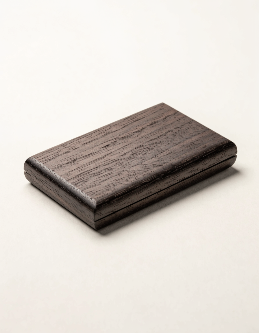 Order Card Case — Walnut — Black walnut card case. 108 × 68 × 13 mm.