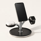 Black Charge Tree holding a phone, watch and earbud case on a warm off-white background.
